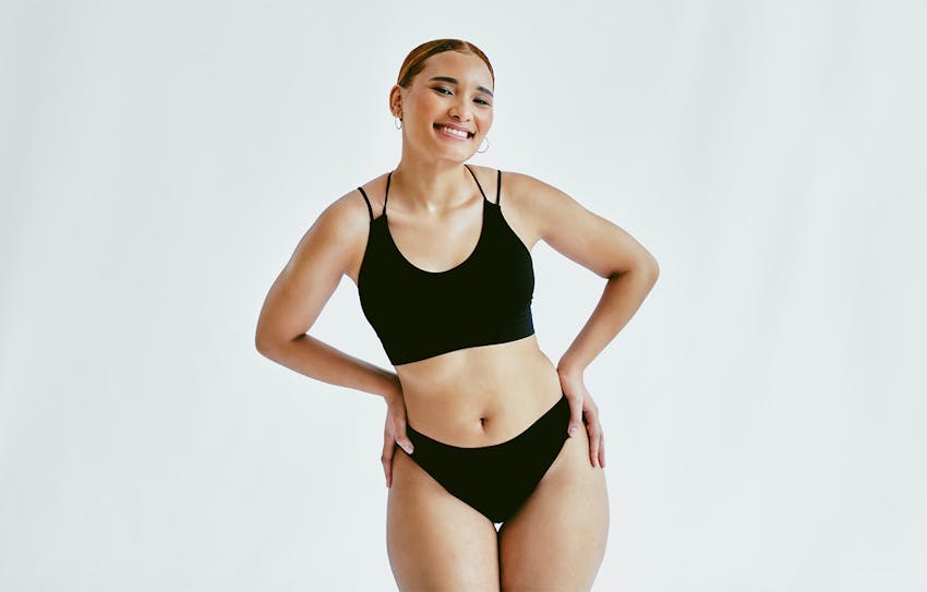 woman smiling with hands on hips