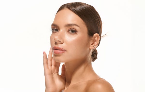 woman's side profile posing touching face