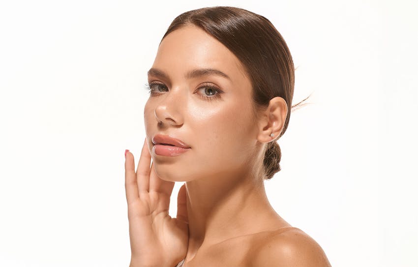 woman's side profile posing touching face