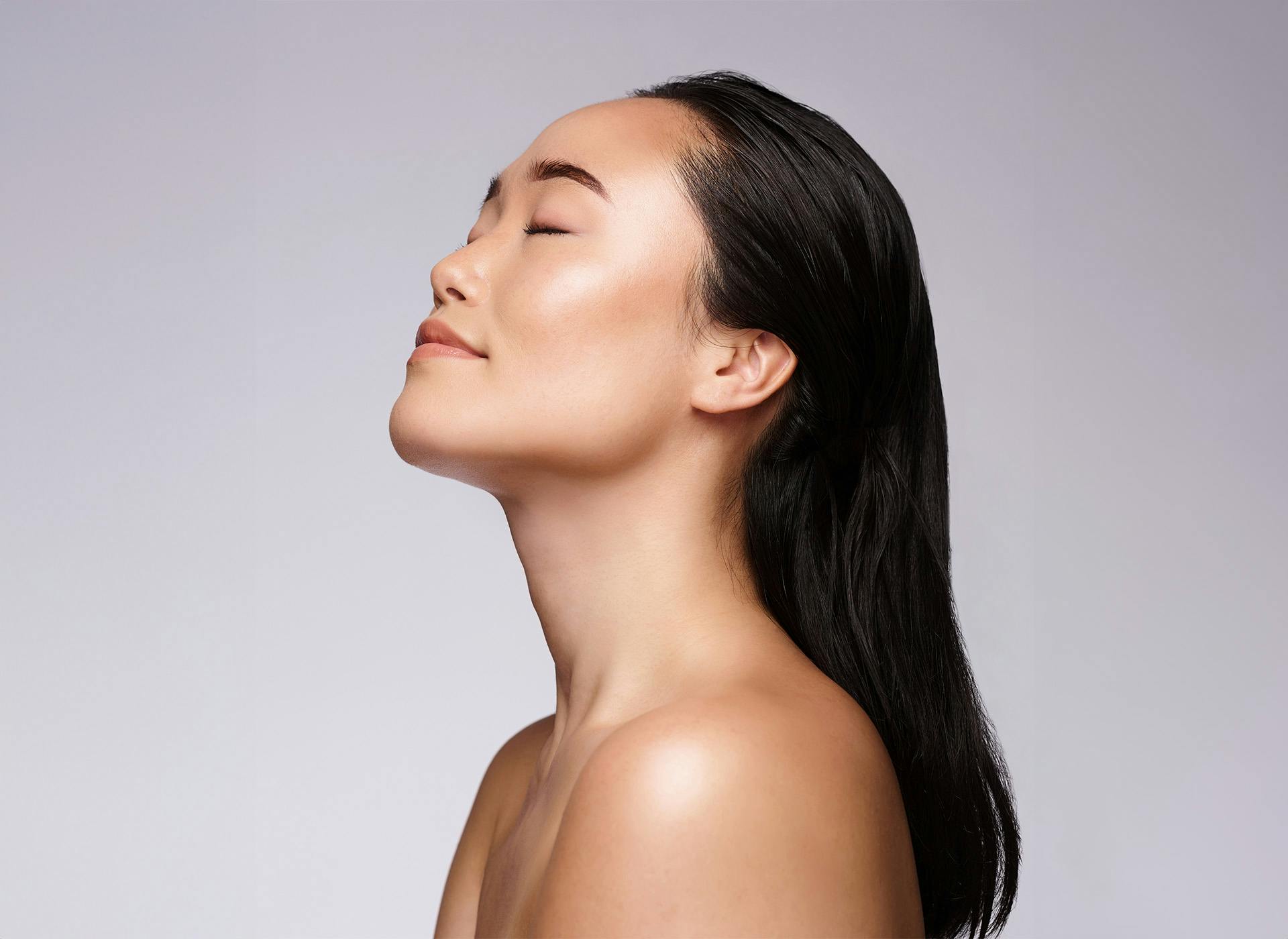 womans side profile with eyes closed looking up