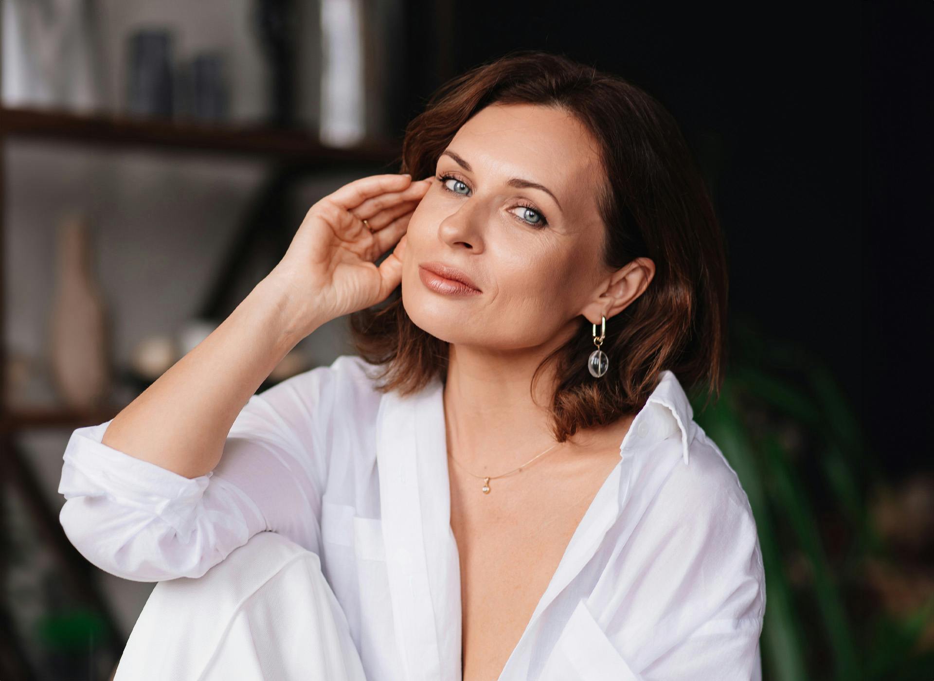 woman looking at camera with hand touching face