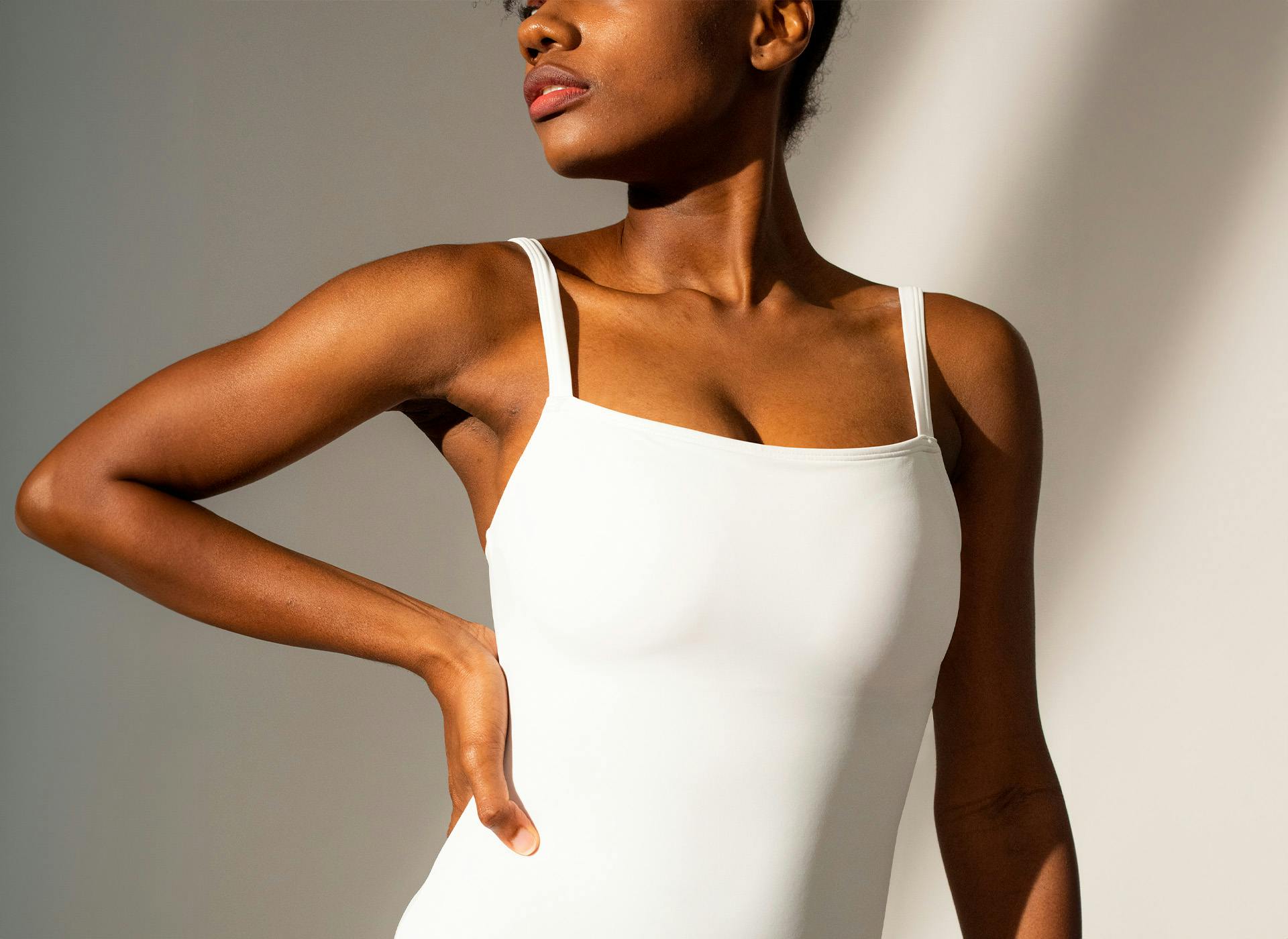 woman looking to the side with hand on hip