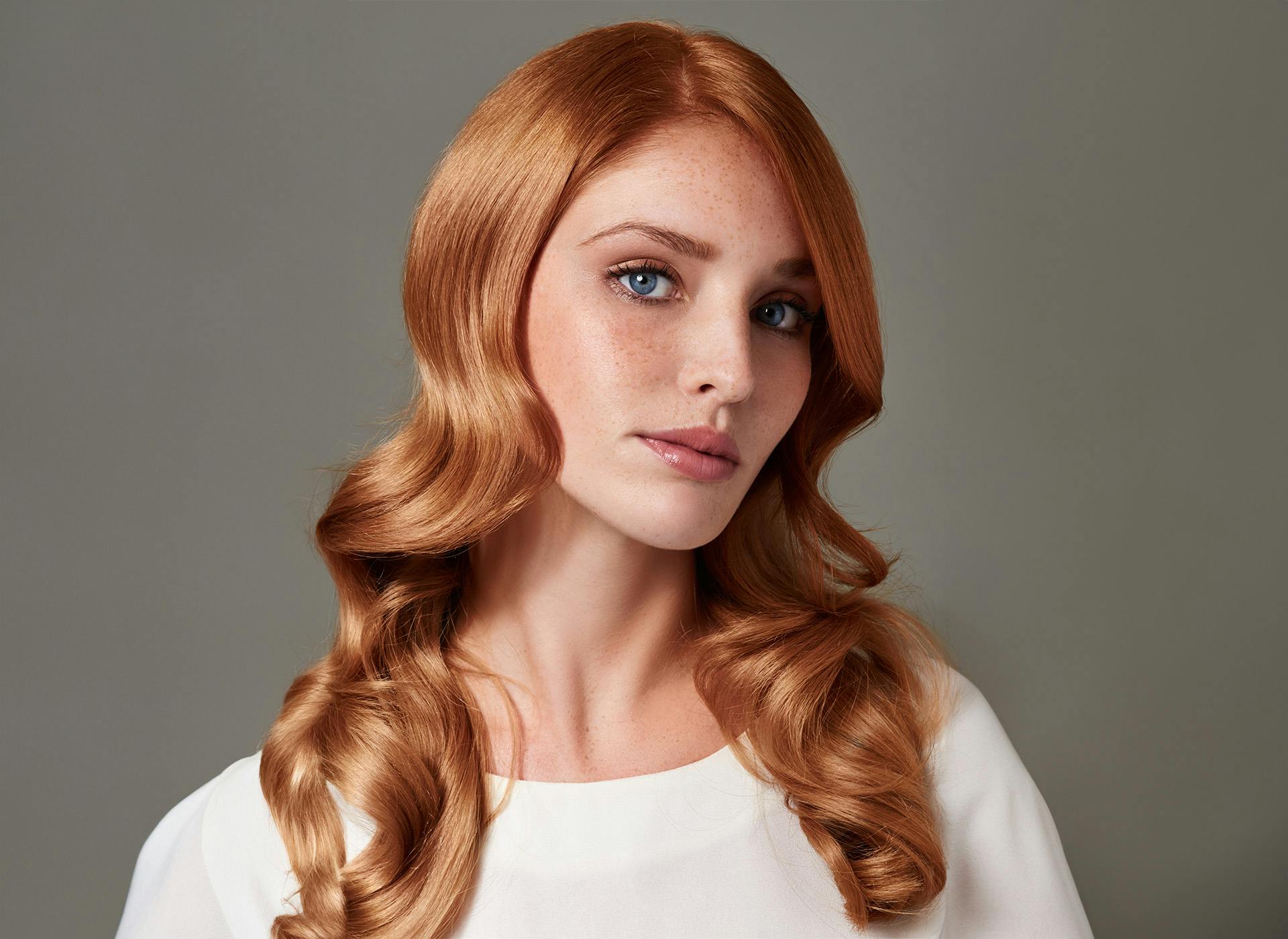 woman with head tilted and curled hair