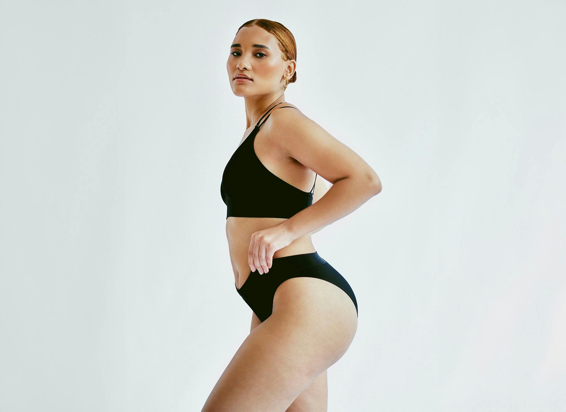 woman with hands on hips looking over