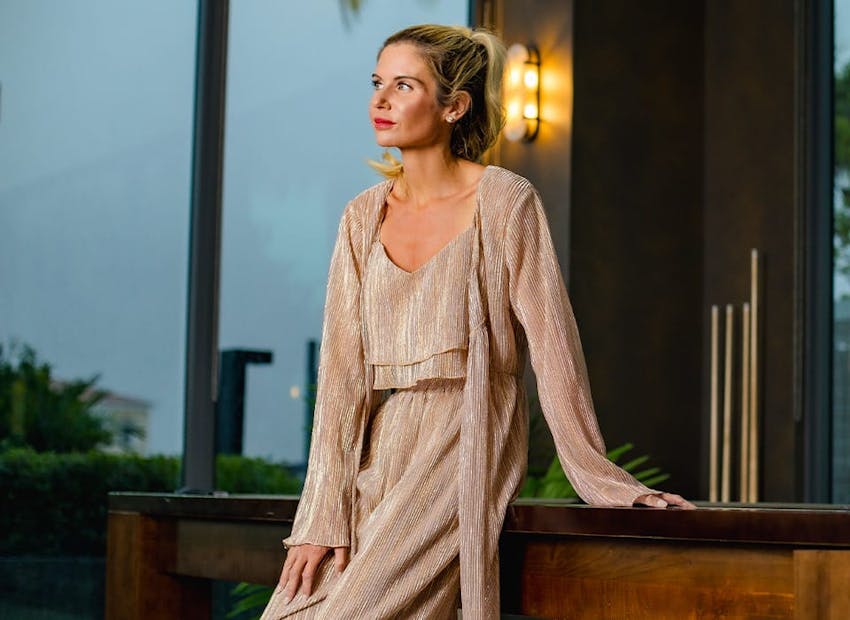 woman outside leaning on railing