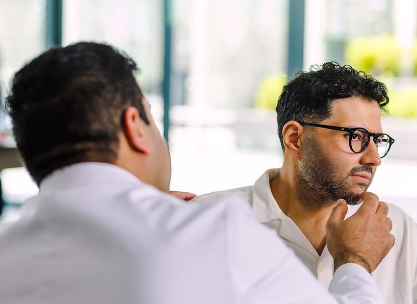 Dr. Chopra looking at patient's chin