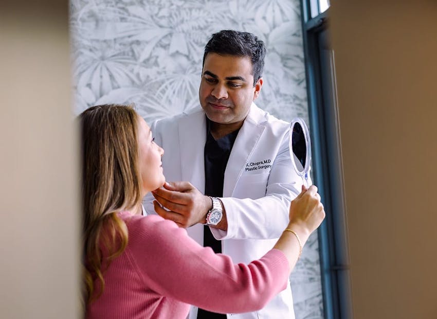 Dr. Chopra looking at patient's face in sunlight