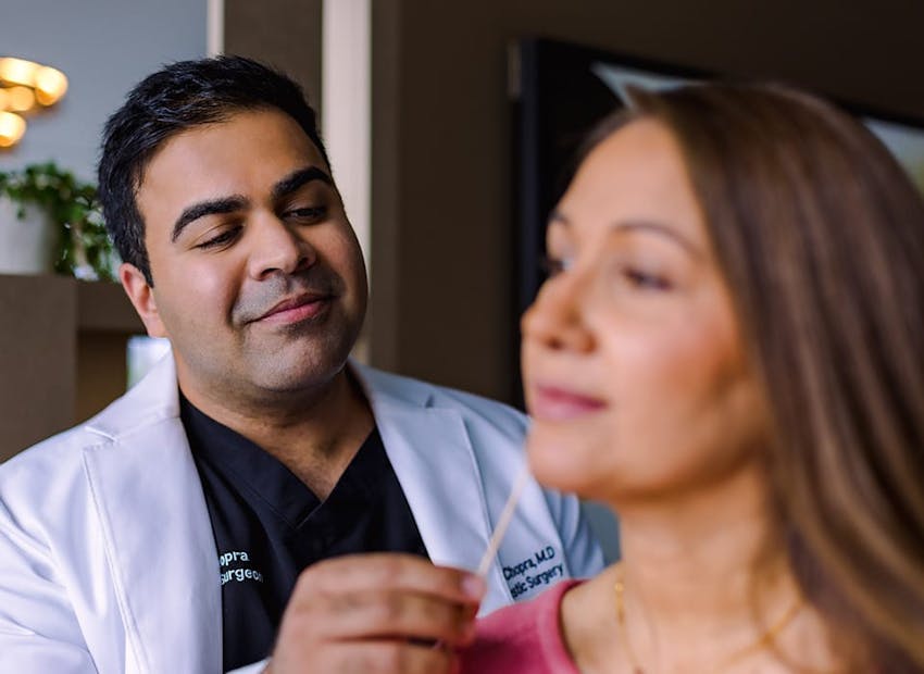 Dr. Chopra looking at patient's face