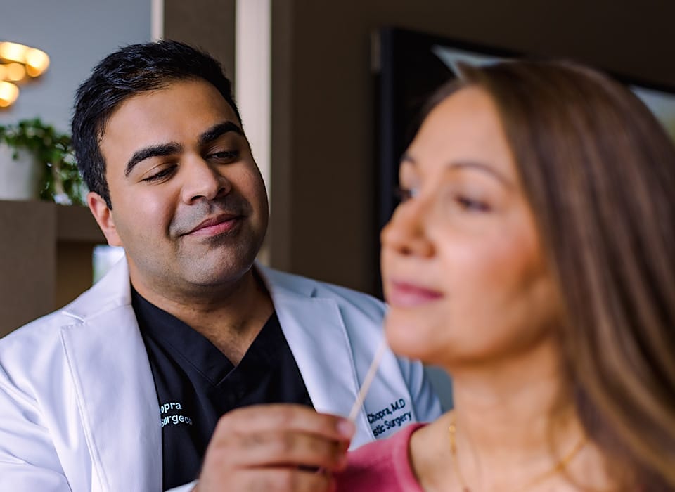 Dr. Chopra looking at patient's face