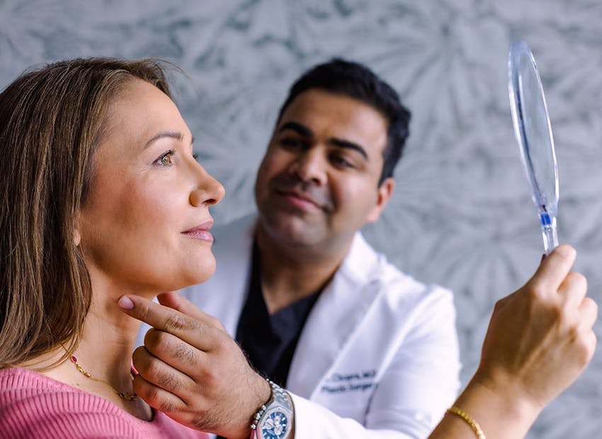 Dr. Chopra touching patient's neck