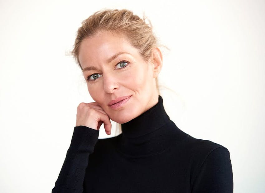 woman with hair up in black turtle neck