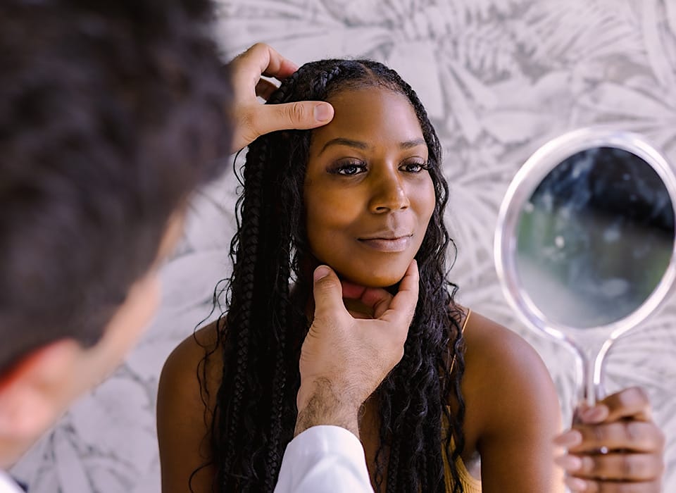 Dr. Chopra with patient looking at her eyelids