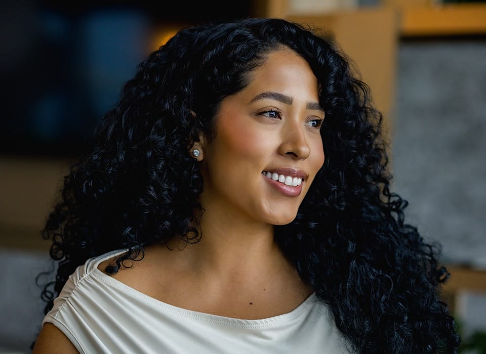 woman with big curly hair looking forward