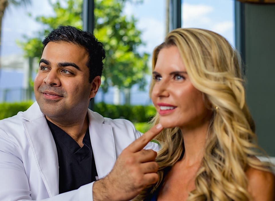 Dr. Chopra pointing to patient's chin