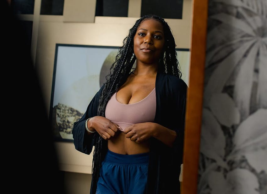 patient looking in full body mirror at herself