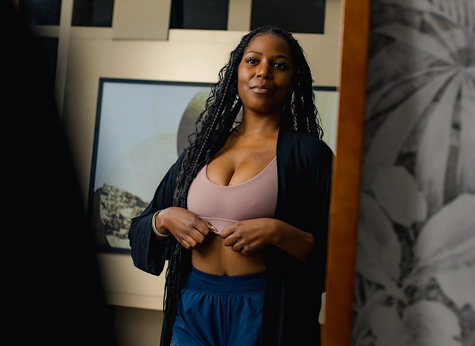 patient looking in full body mirror at herself