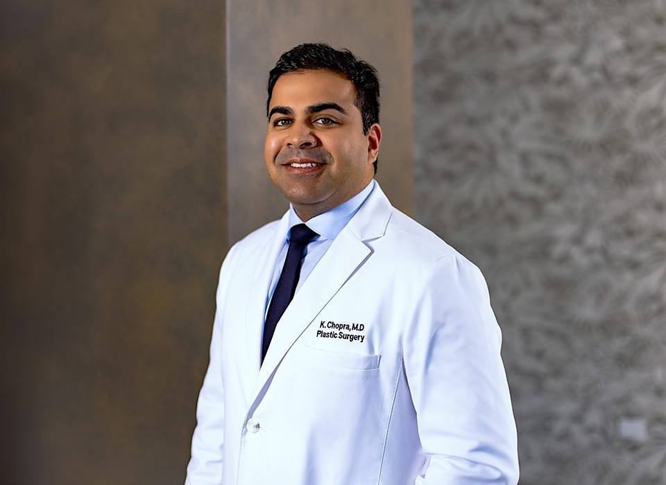 Dr. Chopra in white medical suit