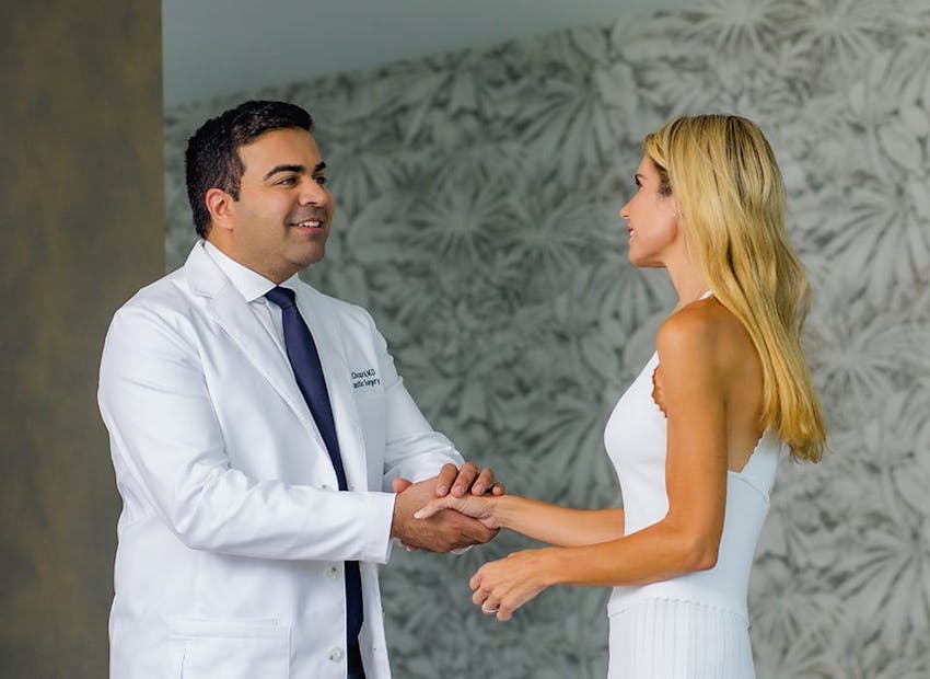 Dr. Chopra shaking hands with female patient
