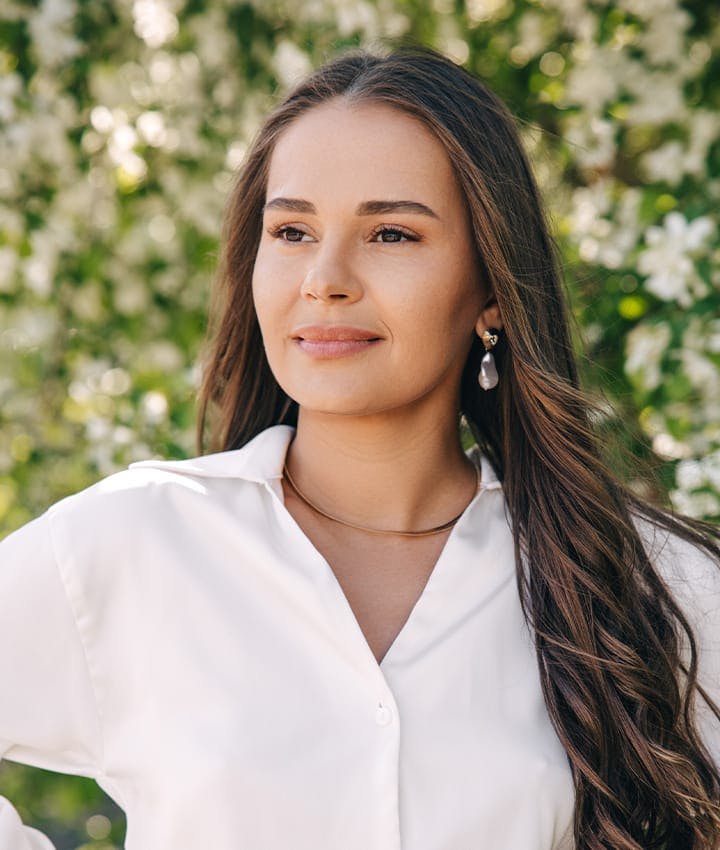 woman in white shirt looking to the left