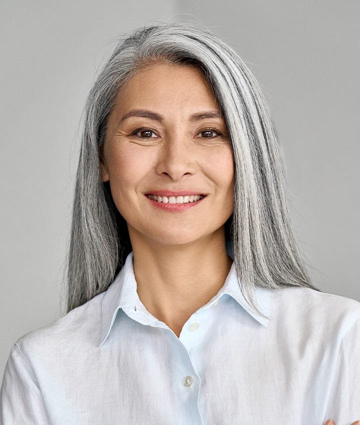 older woman smiling looking forward