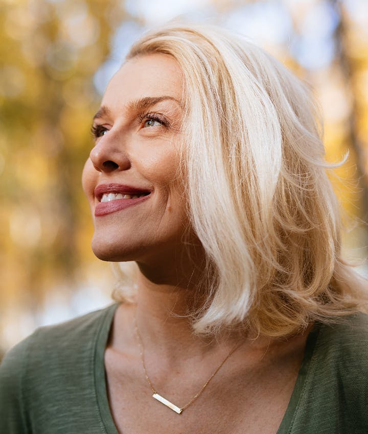 woman looking out towards sun
