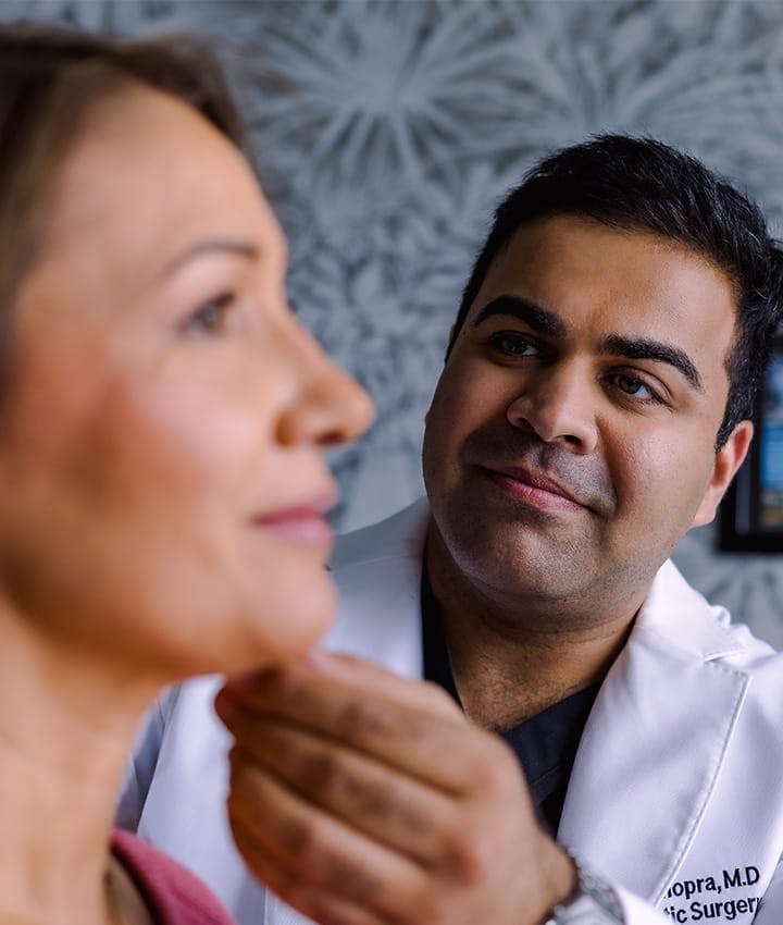 Dr. Chopra looking at patient's neck