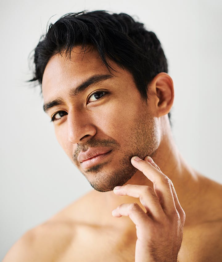 man touching his jaw