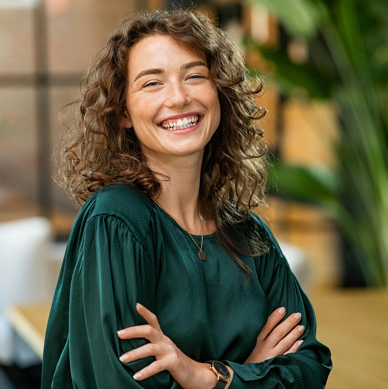 woman smiling with her arms crossed