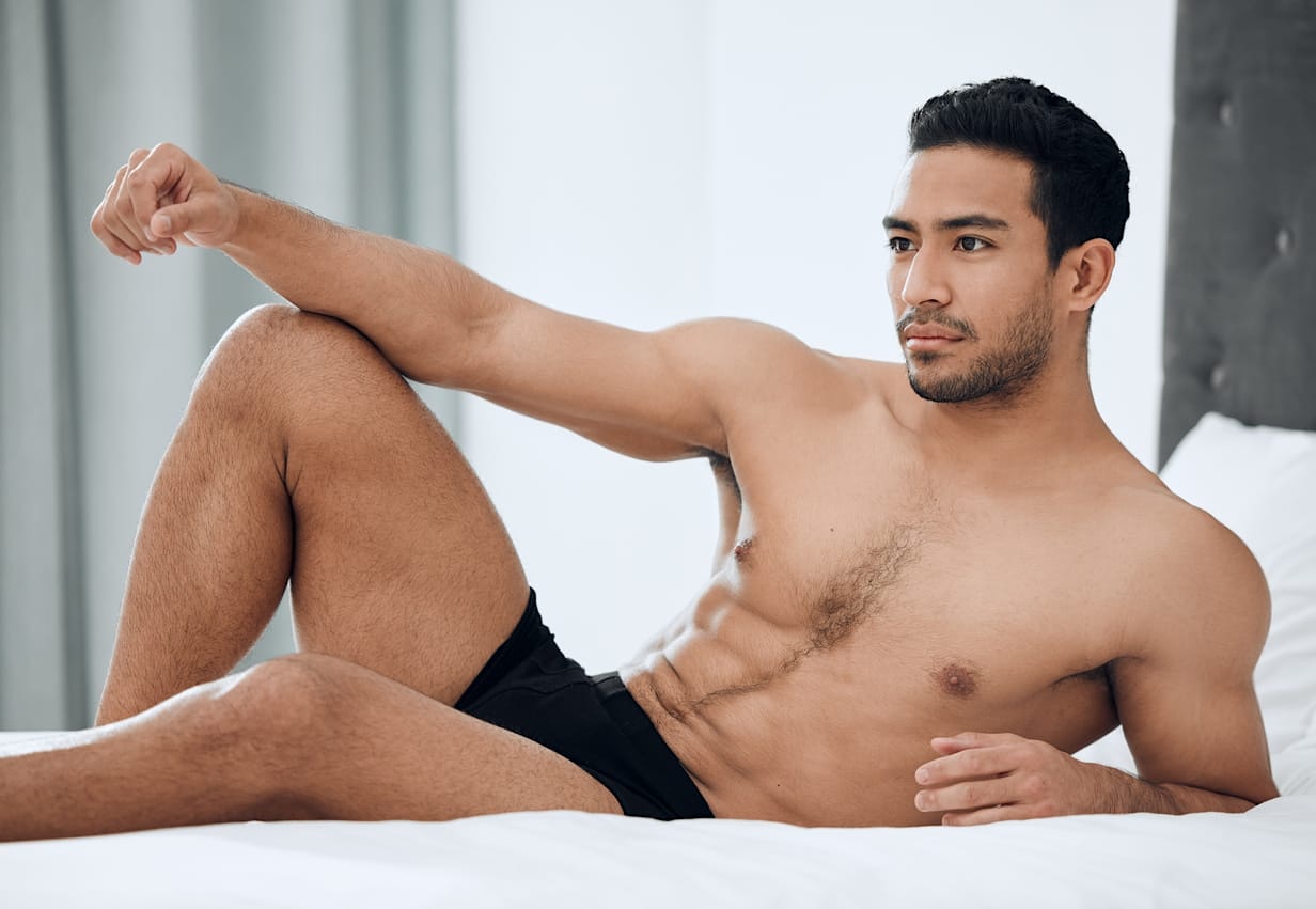 Man posing on bed
