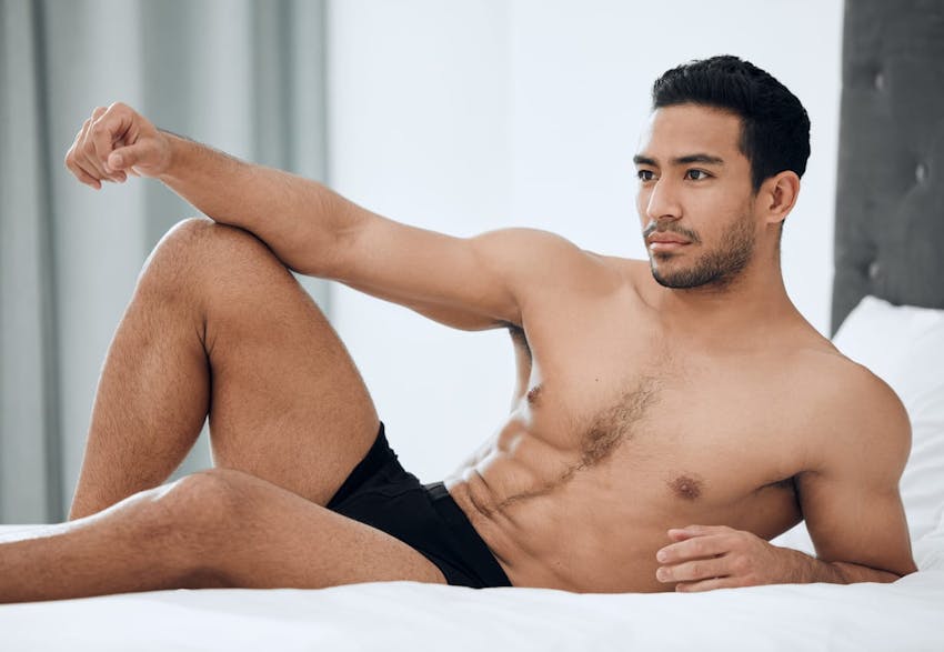 Man posing on bed