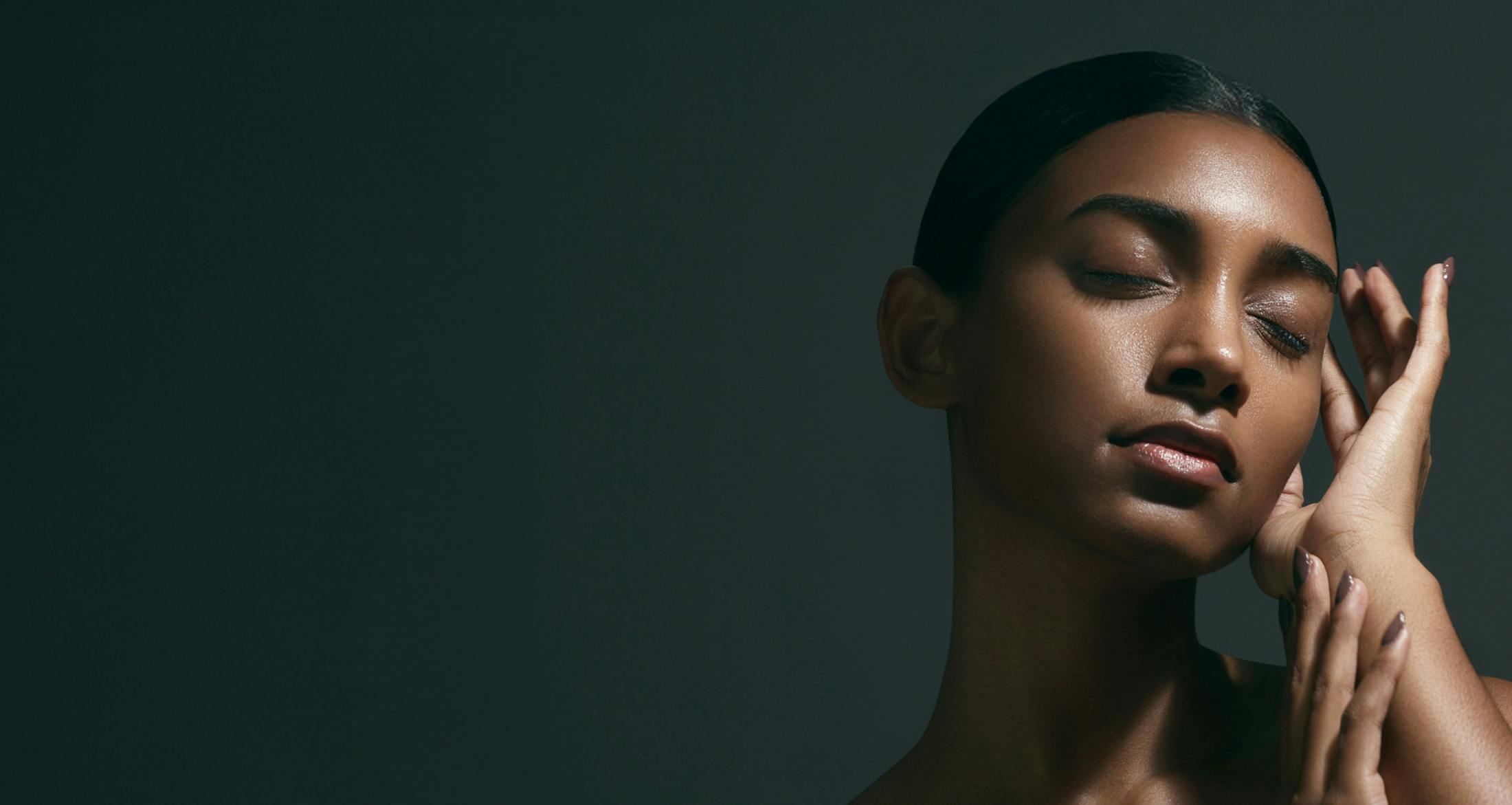 woman touching the side of her face