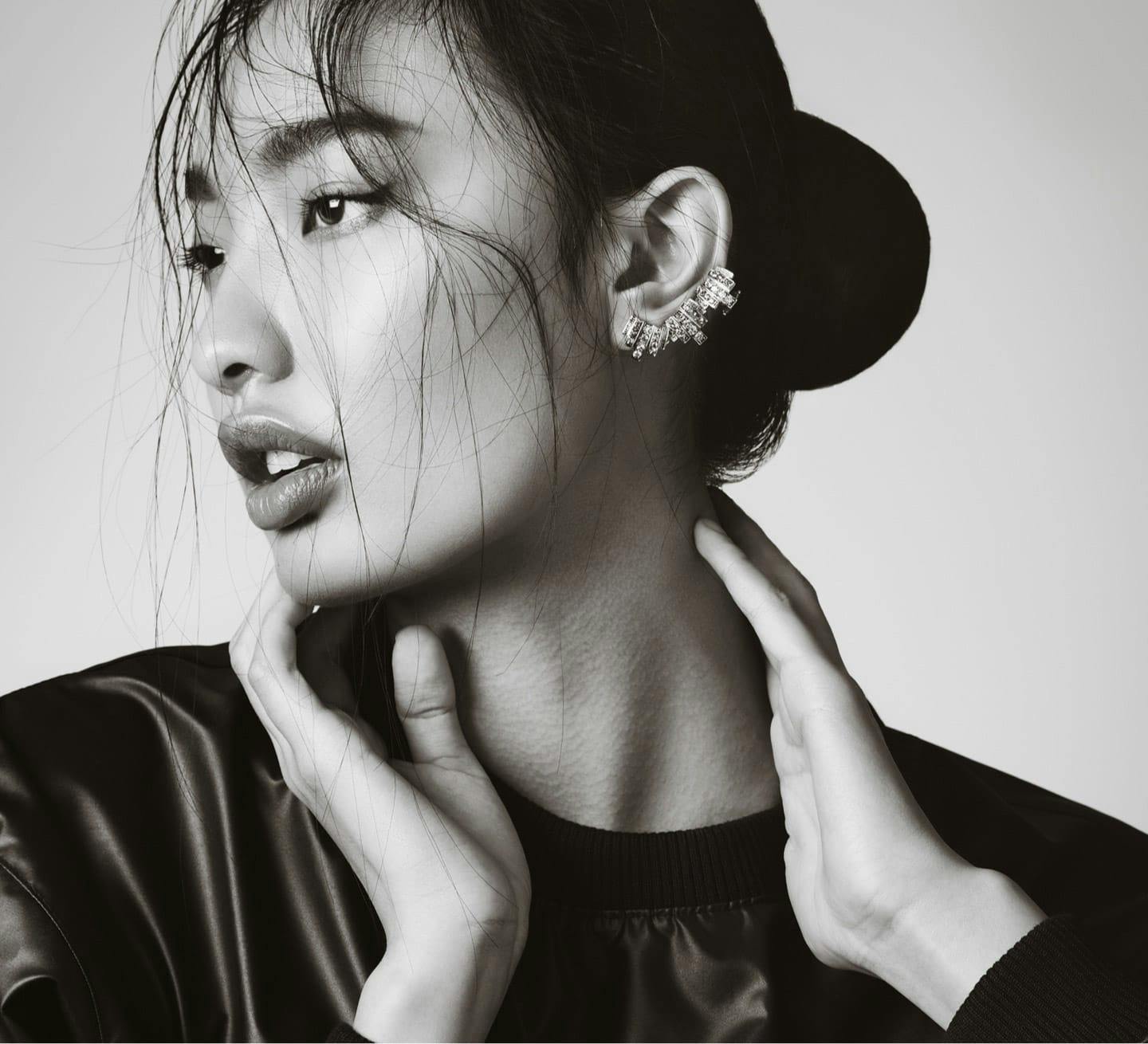 woman touching neck looking to the side