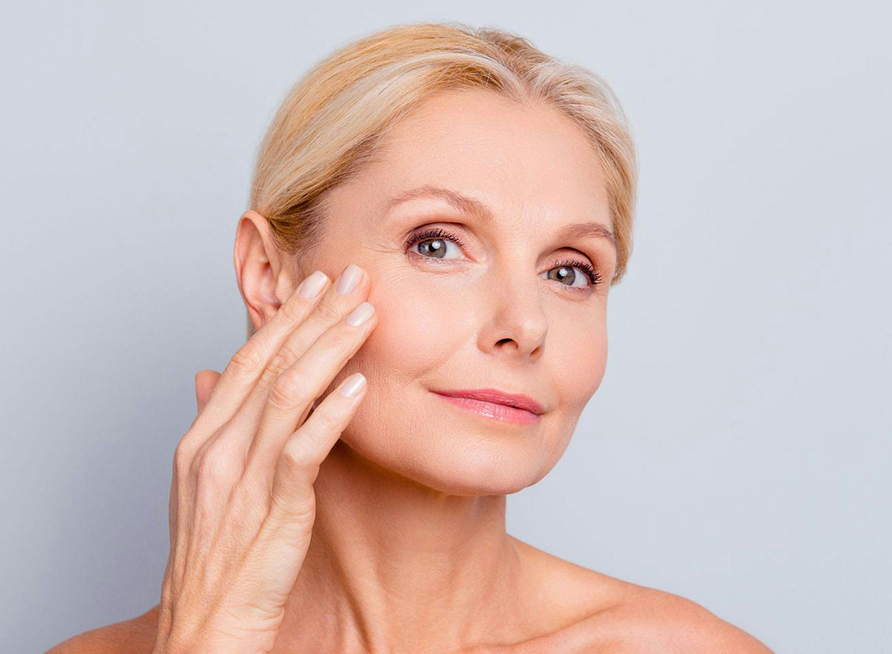 woman touching face and smiling