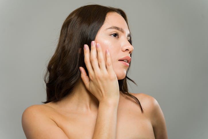 Woman touching her cheek