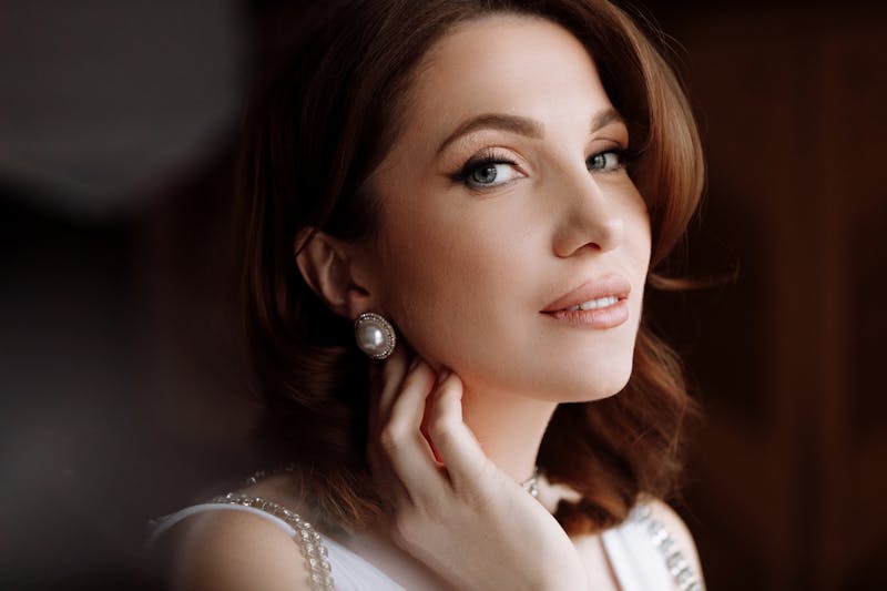 woman smiling with her hand by her ear