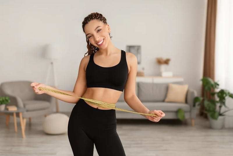 woman with measuring tape around her waist