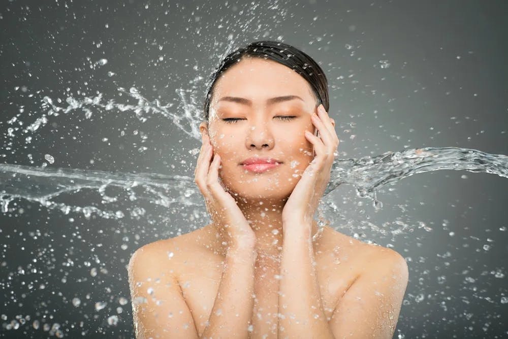 woman washing her face