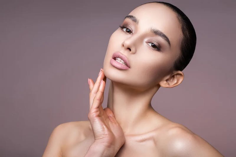woman touching her chin