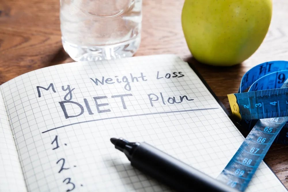 someone writing down their diet plan
