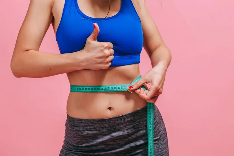 woman with measuring tape around her waist