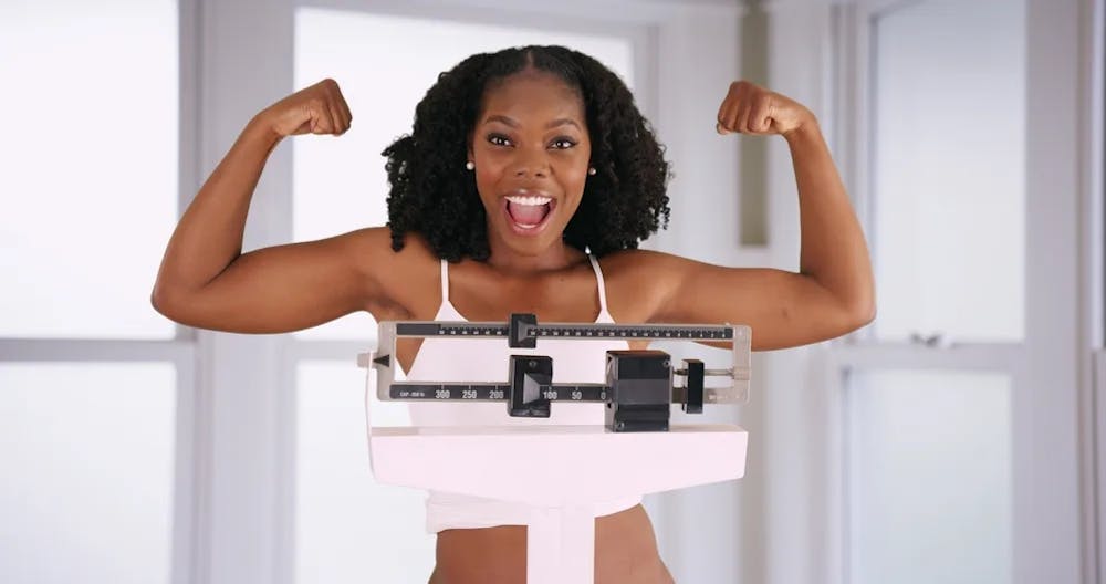 woman flexing on scale