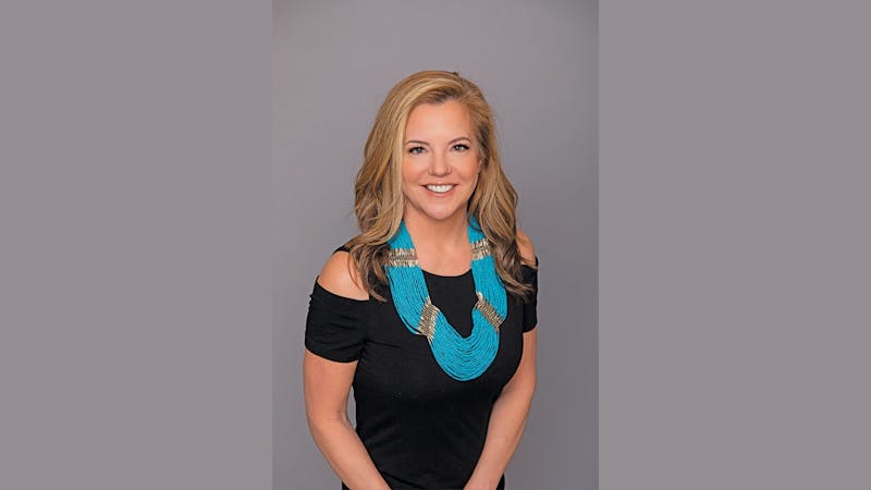 blonde woman with big blue necklace