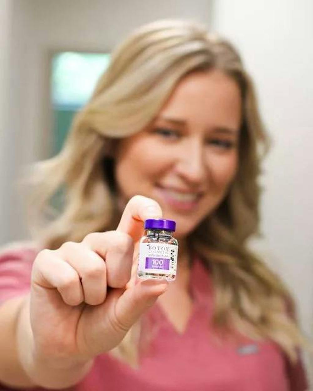 woman holding botox
