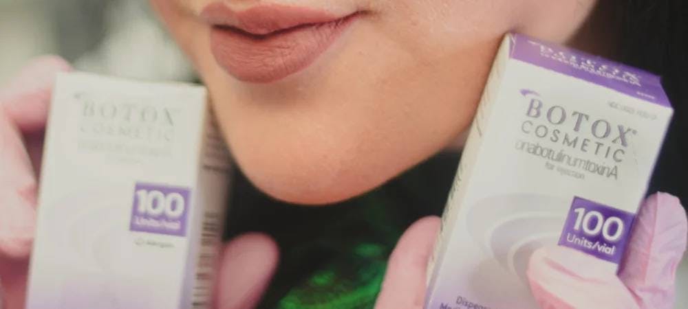 woman holding botox boxes