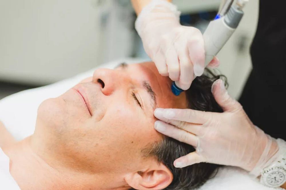 man getting face treatment