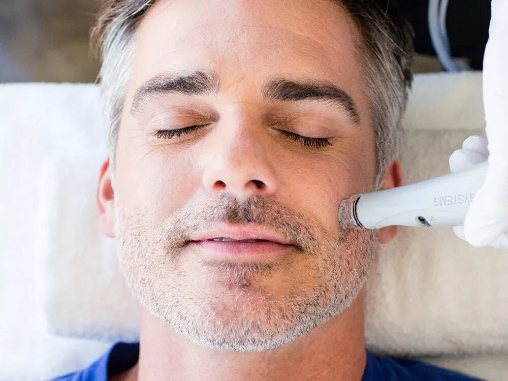 man getting face treatment