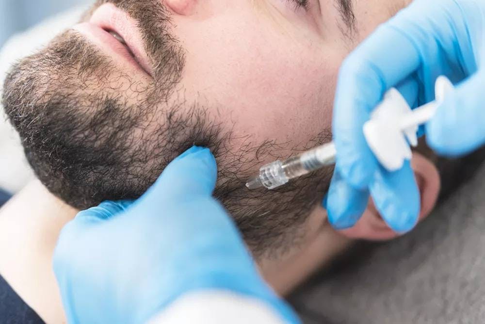 man getting botox injection