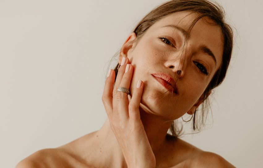 women touching her face