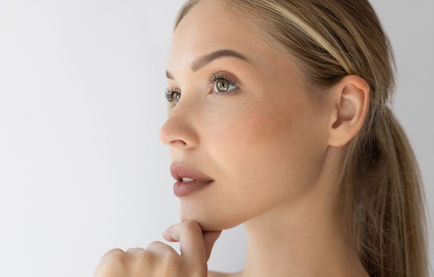 A woman holding her chin