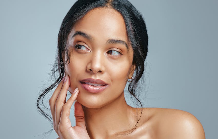 model posing holding her face